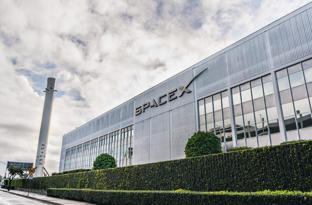 Dec 8, 2019 Hawthorne / Los Angeles / CA / USA - SpaceX (Space Exploration Technologies Corp.) headquarters; Falcon 9 rocket displayed on the left; SpaceX is a private American aerospace manufacturer